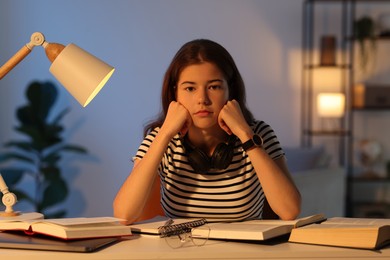 Preparing for exam. Student with books at table indoors