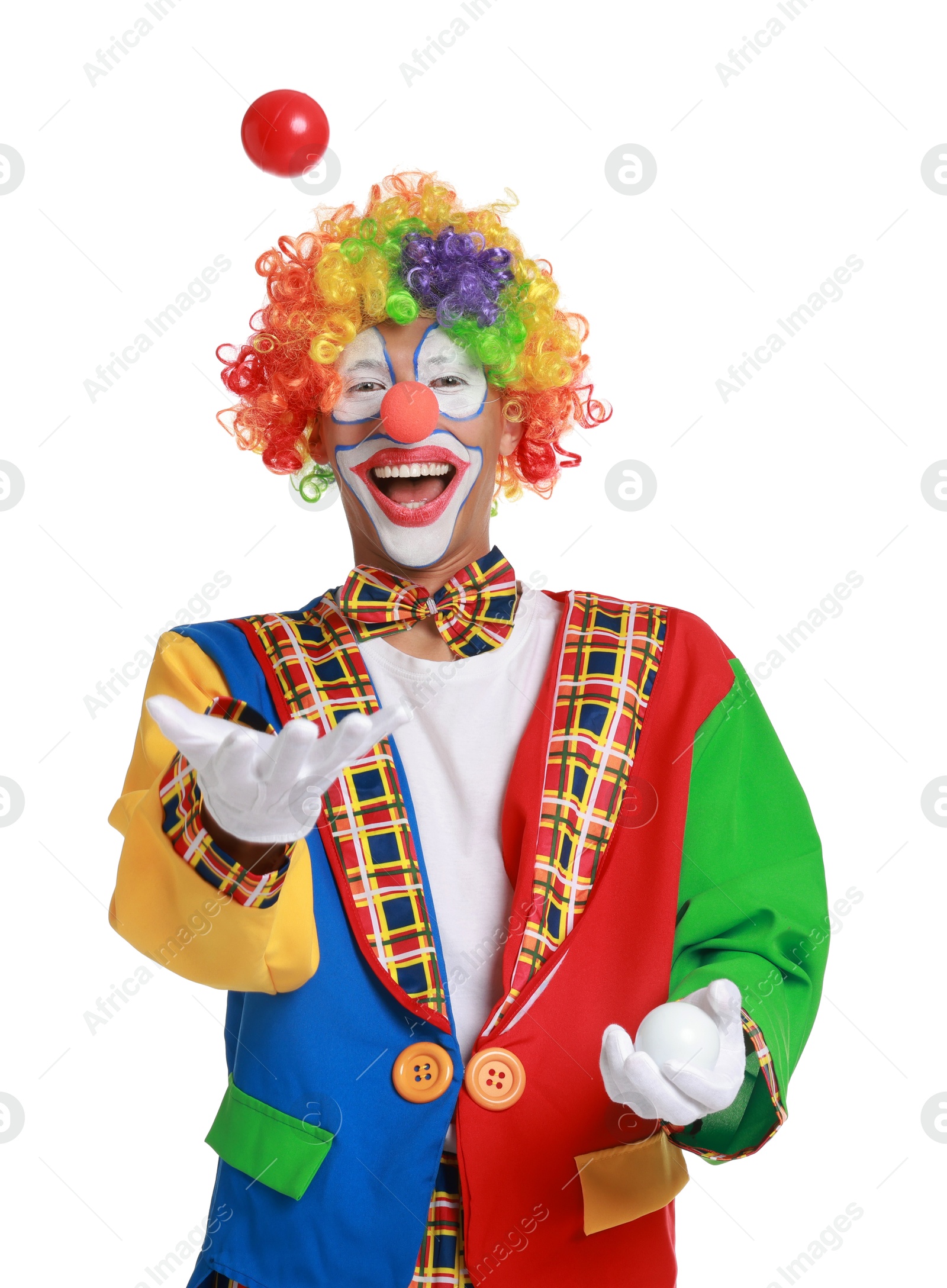 Photo of Happy clown juggling balls on white background