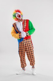 Photo of Portrait of clown laughing on light background, space for text