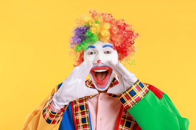 Photo of Portrait of clown screaming on yellow background