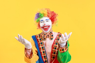 Photo of Portrait of happy clown on yellow background