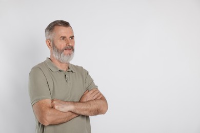 Photo of Portrait of senior man on white background, space for text