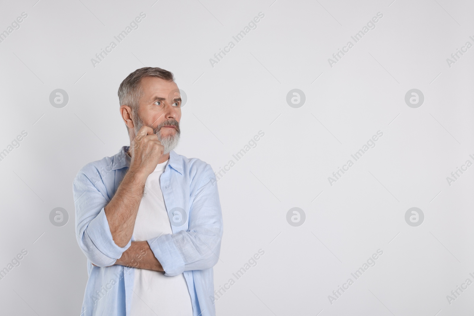 Photo of Portrait of senior man on white background, space for text