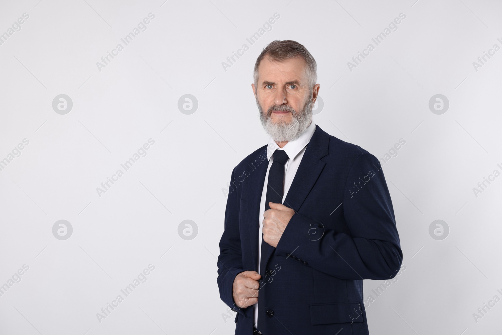 Photo of Portrait of senior man in suit on white background, space for text