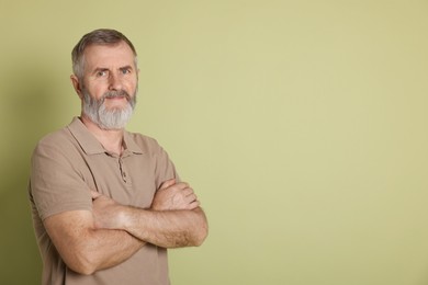 Photo of Portrait of senior man on green background, space for text