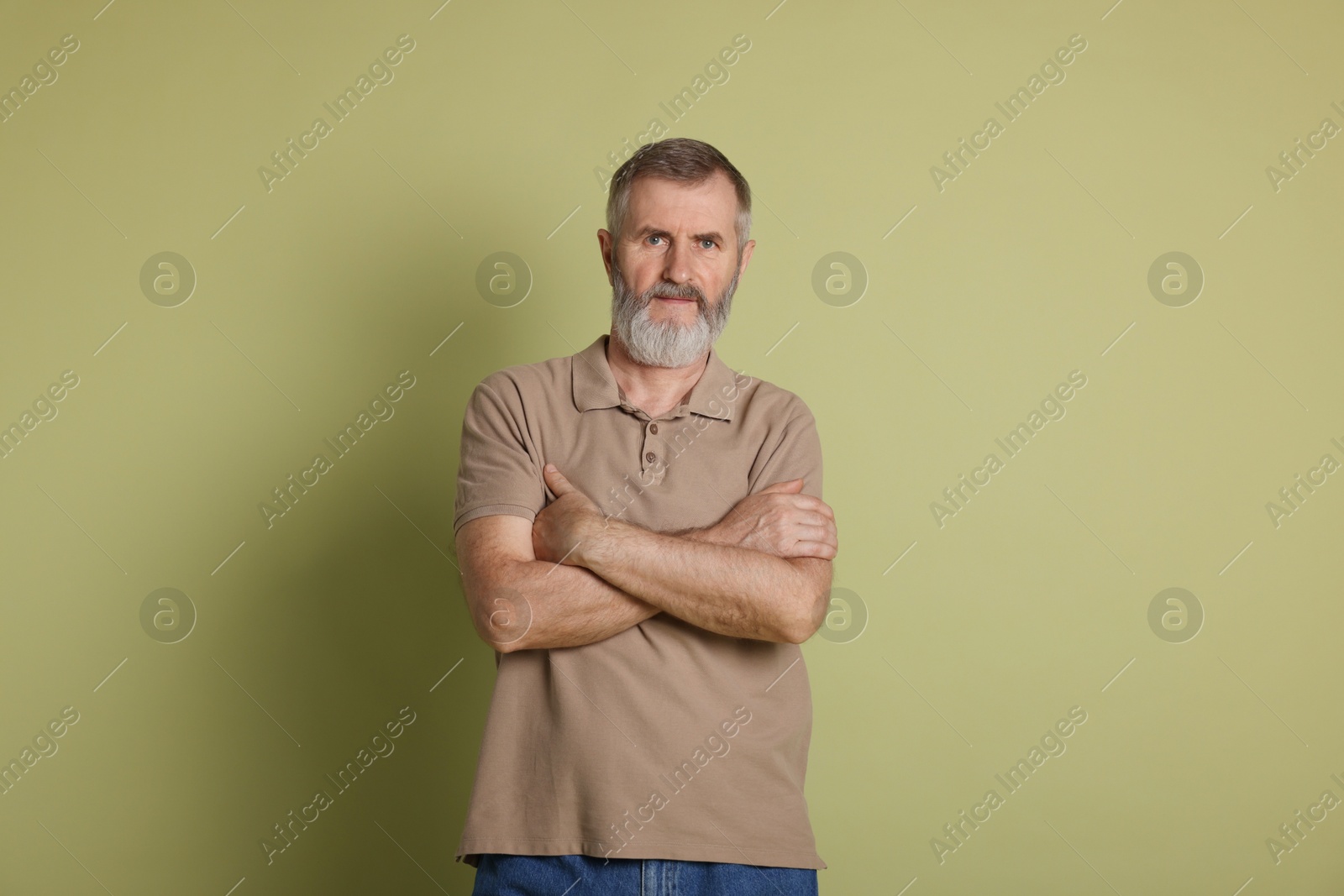 Photo of Portrait of senior man on green background