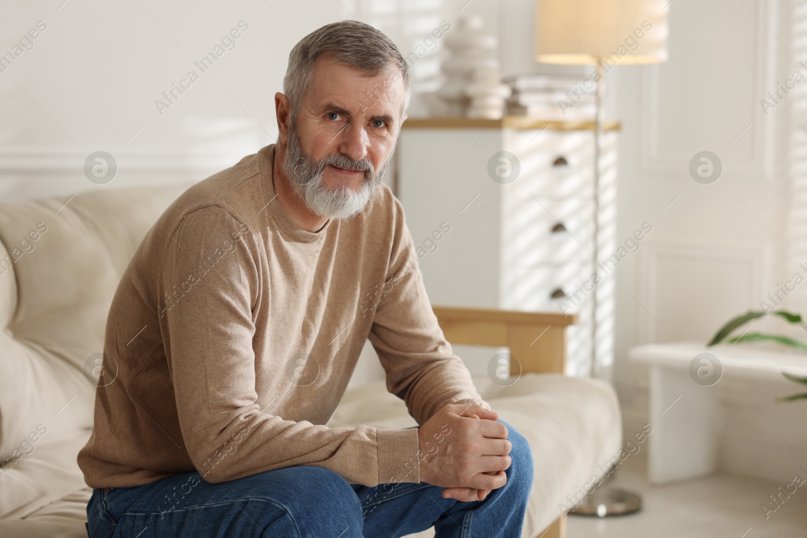 Photo of Portrait of handsome senior man at home