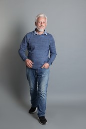 Photo of Full length portrait of senior man on grey background