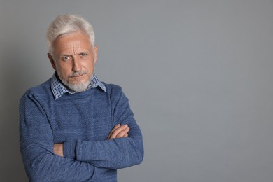 Photo of Portrait of senior man on grey background, space for text