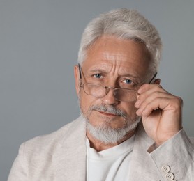 Photo of Portrait of senior man on grey background