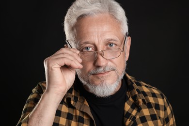 Photo of Portrait of senior man on black background