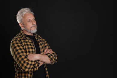 Photo of Portrait of senior man on black background, space for text