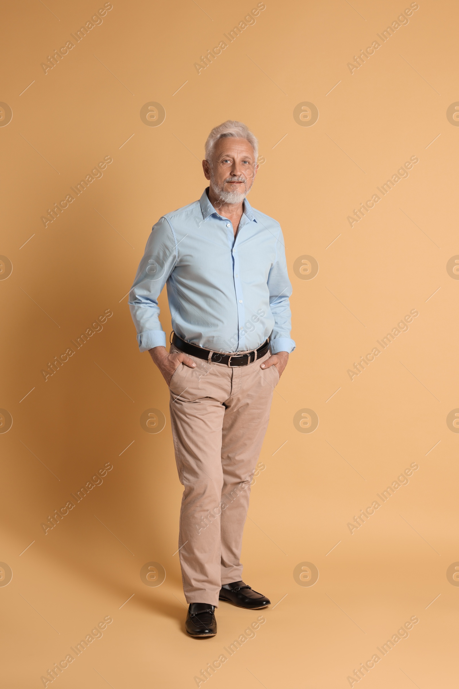 Photo of Full length portrait of senior man on beige background