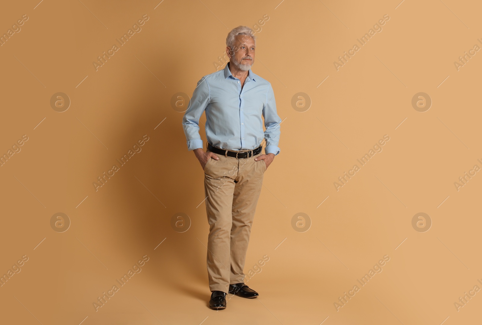 Photo of Full length portrait of senior man on beige background