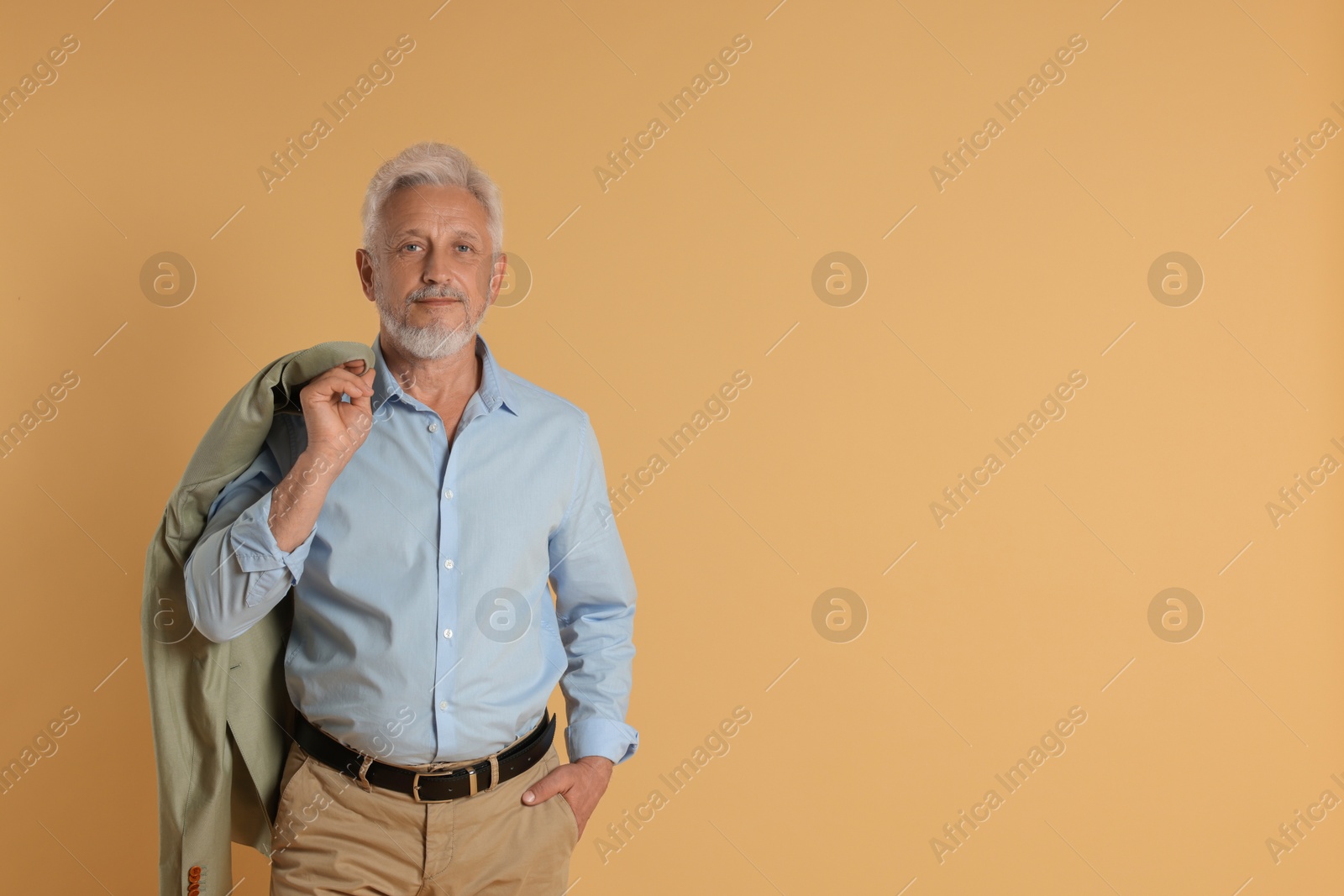 Photo of Portrait of senior man on beige background, space for text