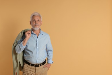 Photo of Portrait of senior man on beige background, space for text