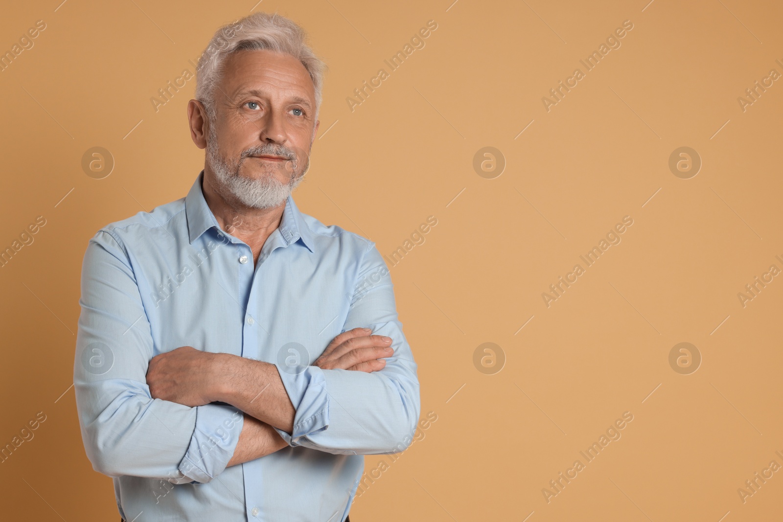 Photo of Portrait of senior man on beige background, space for text