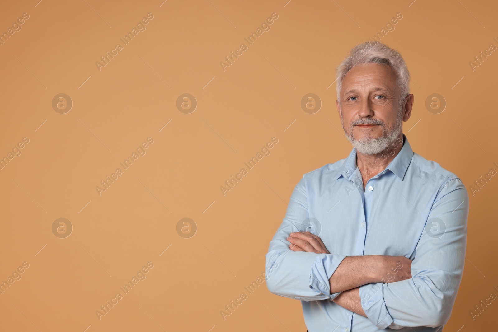 Photo of Portrait of senior man on beige background, space for text