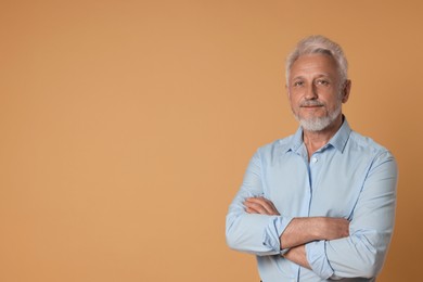 Photo of Portrait of senior man on beige background, space for text