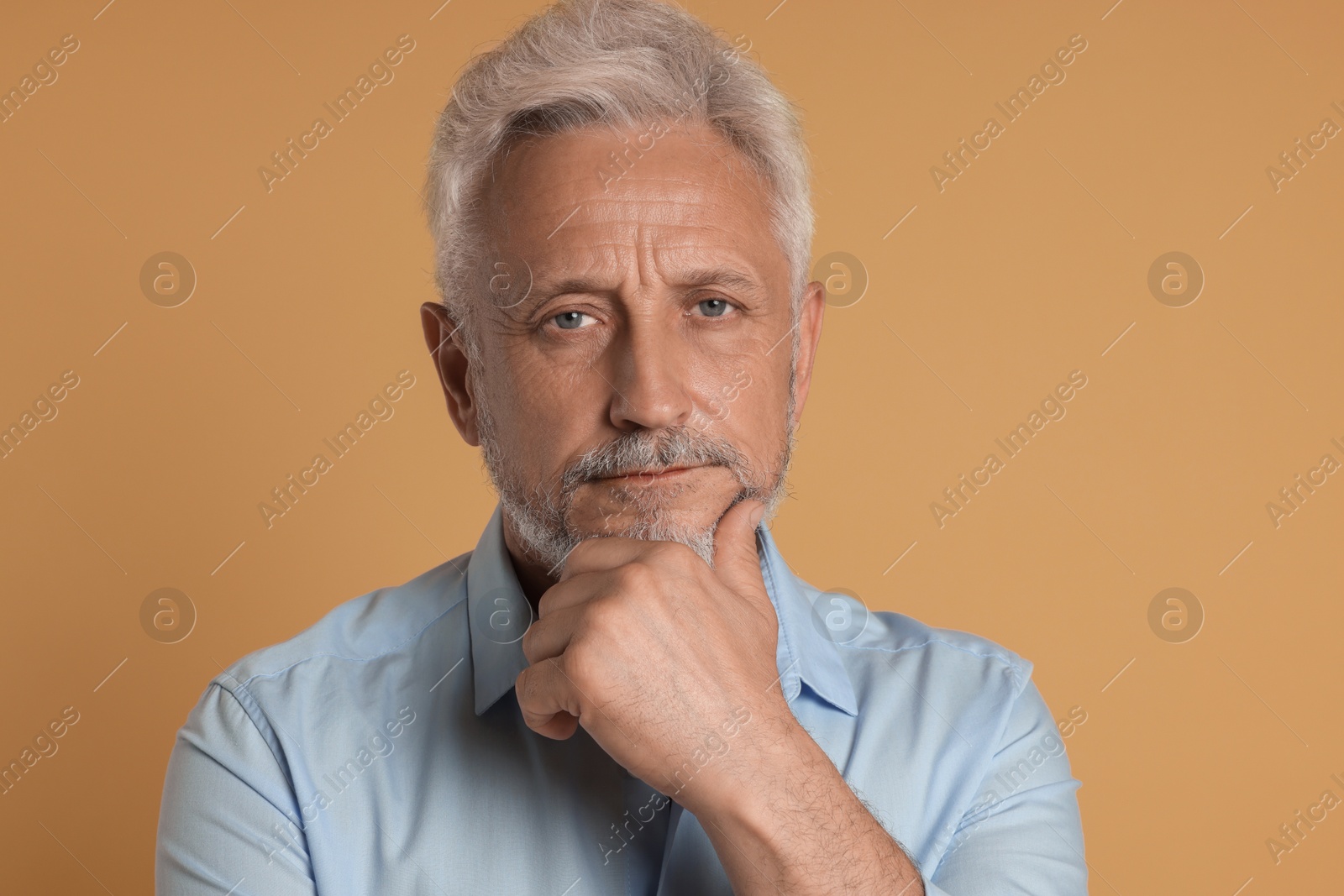 Photo of Portrait of senior man on beige background