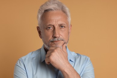 Photo of Portrait of senior man on beige background