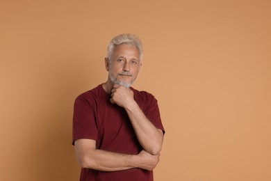 Photo of Portrait of senior man on beige background