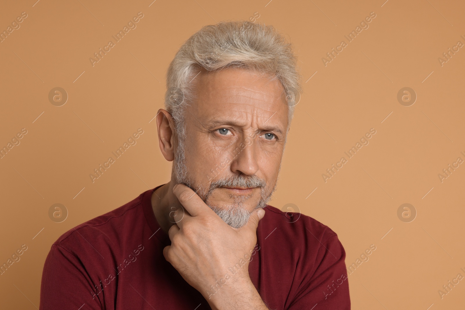 Photo of Portrait of senior man on beige background