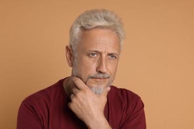 Photo of Portrait of senior man on beige background