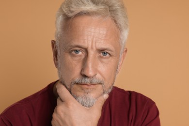 Photo of Portrait of senior man on beige background