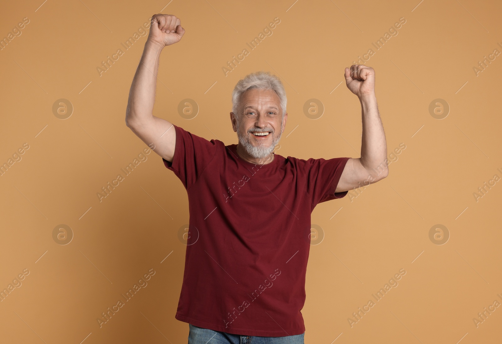 Photo of Portrait of happy senior man on beige background