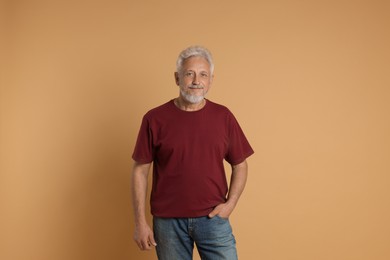 Photo of Portrait of senior man on beige background