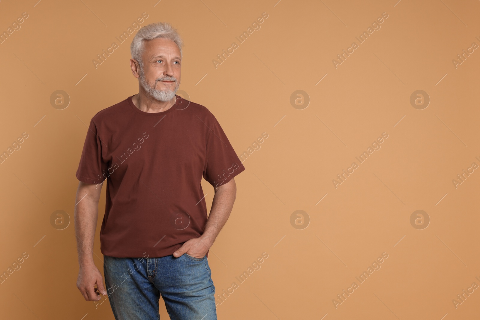 Photo of Portrait of senior man on beige background, space for text