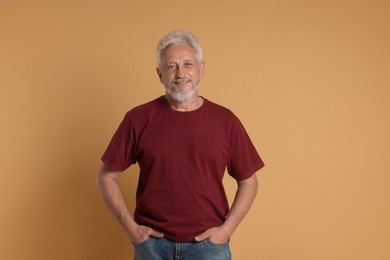 Photo of Portrait of senior man on beige background