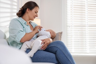 Photo of Mother feeding her cute baby at home