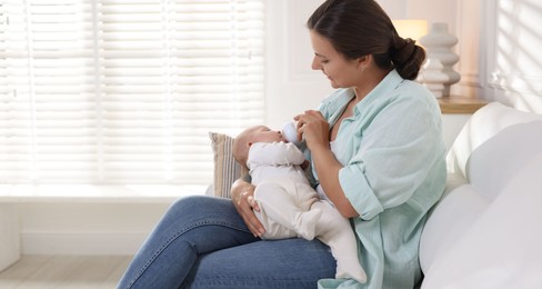 Photo of Mother feeding her cute baby at home