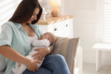 Photo of Mother with her cute little baby on sofa at home