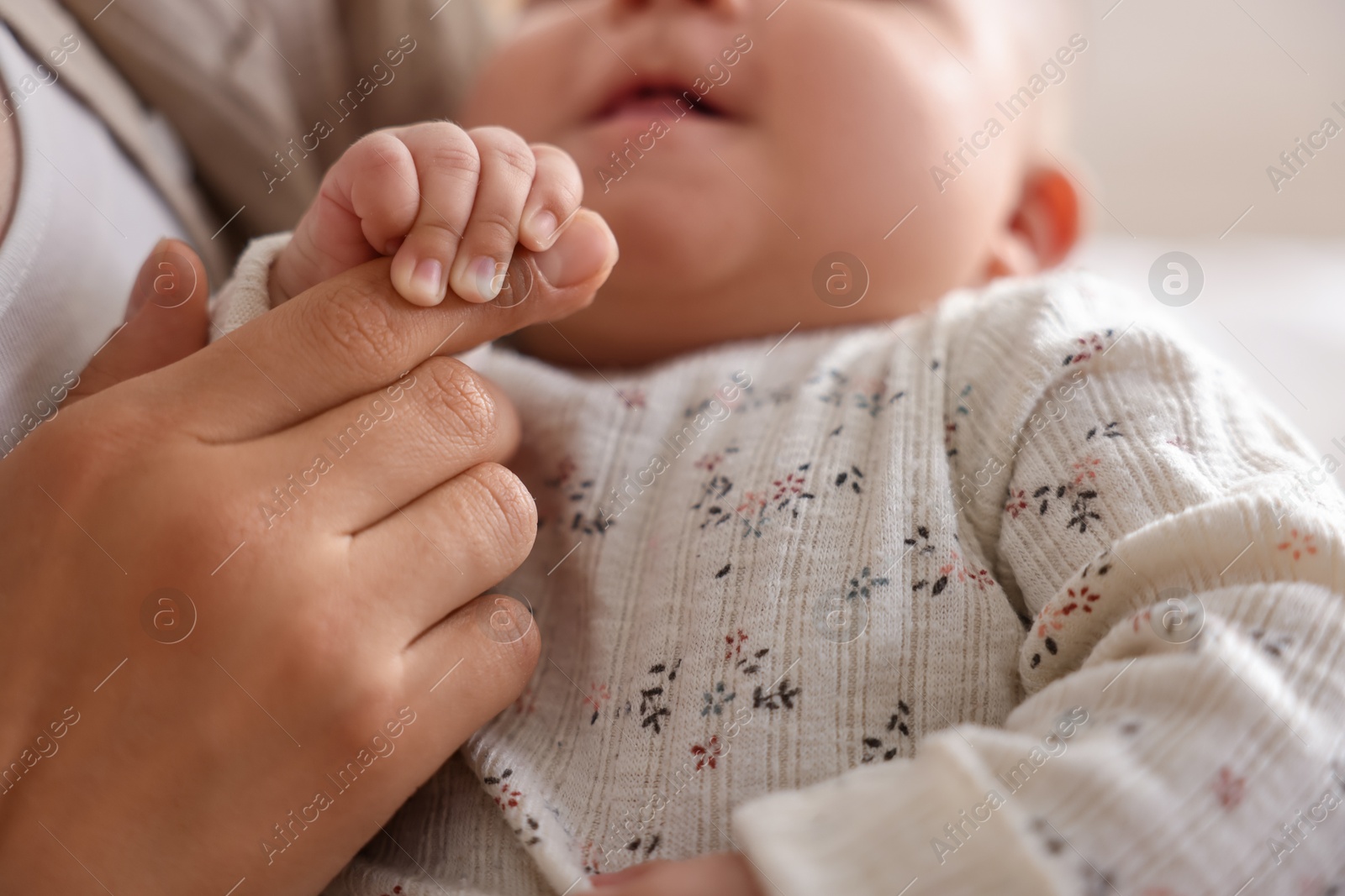 Photo of Mother with her cute little baby at home, closeup