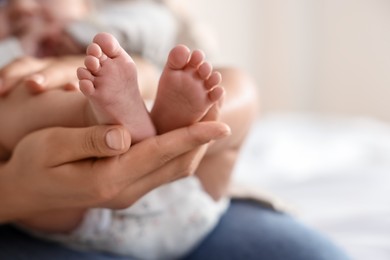 Photo of Mother with her cute little baby at home, closeup. Space for text