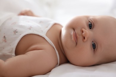 Photo of Cute little baby lying on bed at home