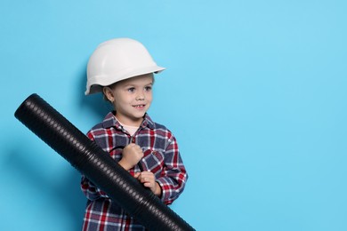 Photo of Little girl with blueprint tube pretending to be architect on light blue background, space for text. Dreaming of future profession