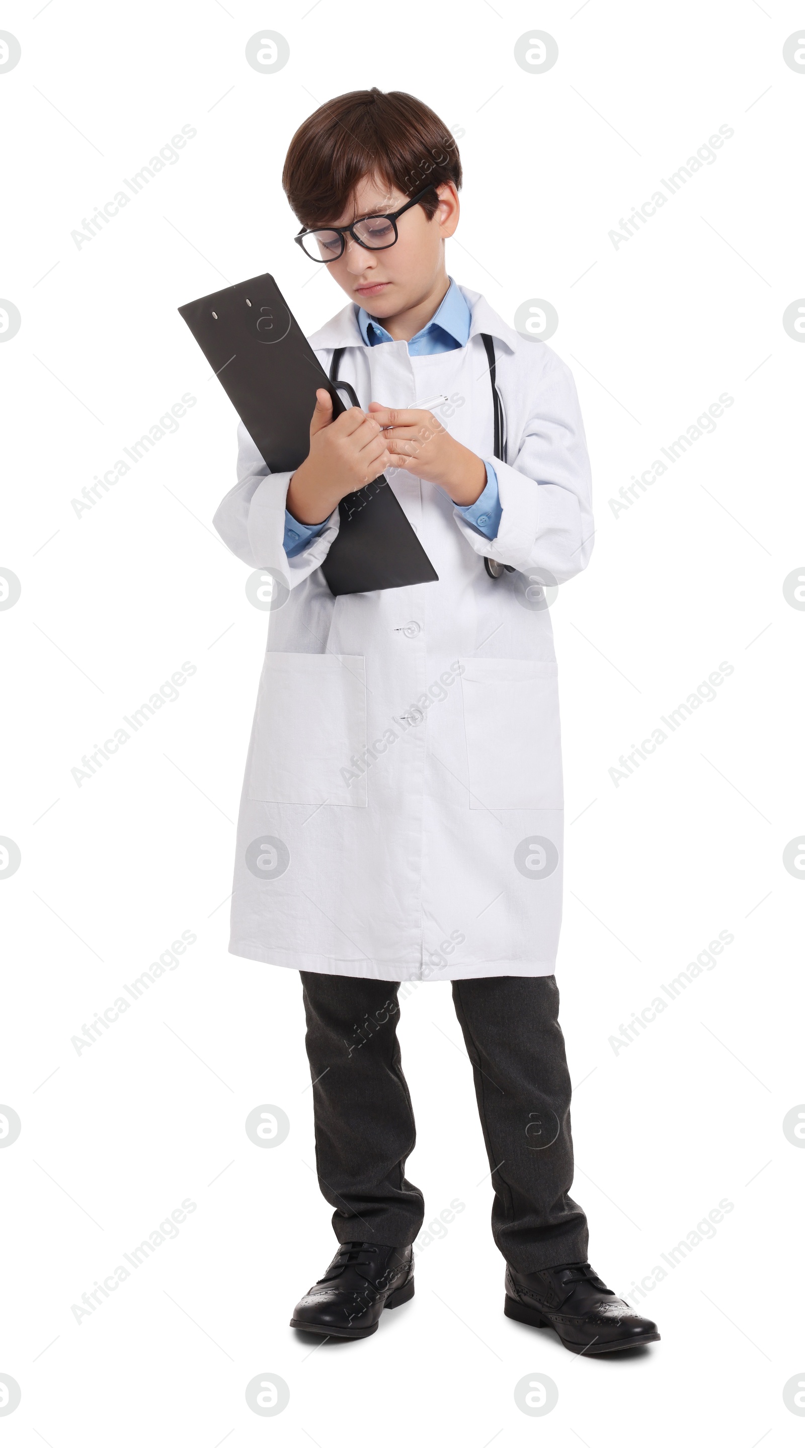 Photo of Boy with stethoscope and clipboard pretending to be doctor on white background. Dreaming of future profession