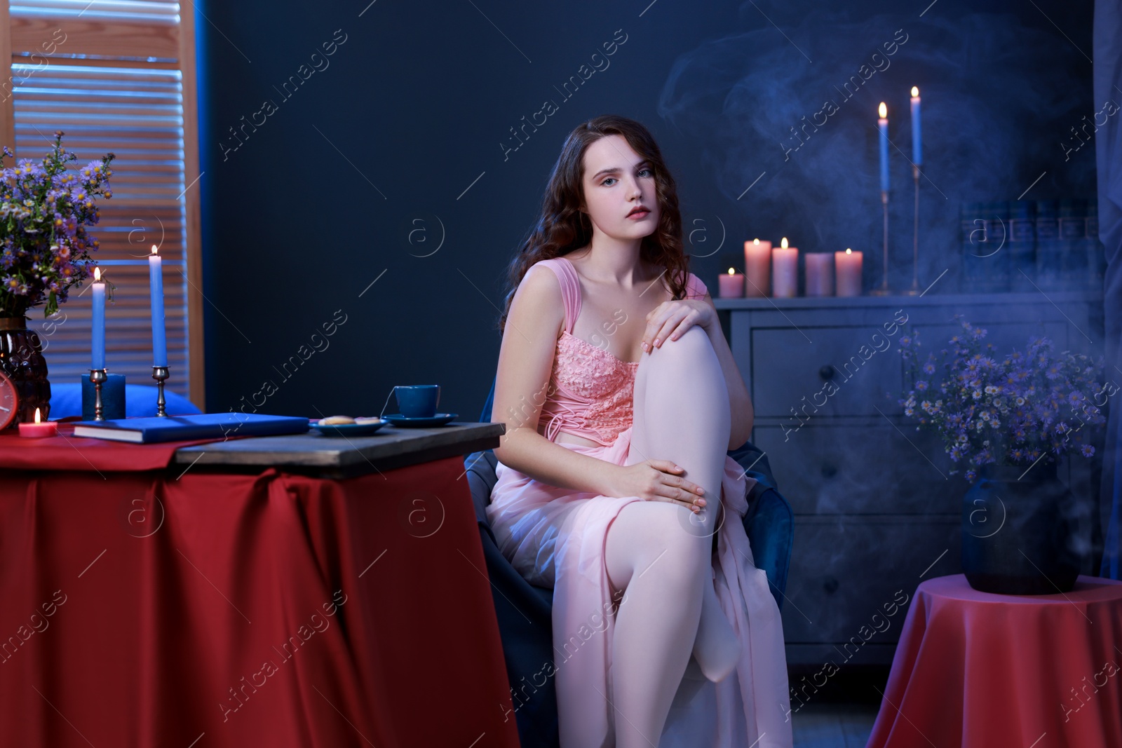 Photo of Beautiful young woman sitting in room. Fashion vintage style portrait