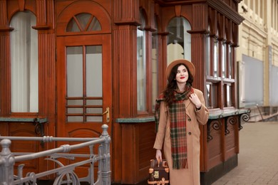 Photo of Beautiful woman with suitcase at railway station