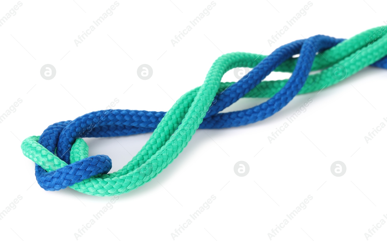 Photo of Colorful ropes tied in knot isolated on white. Unity concept