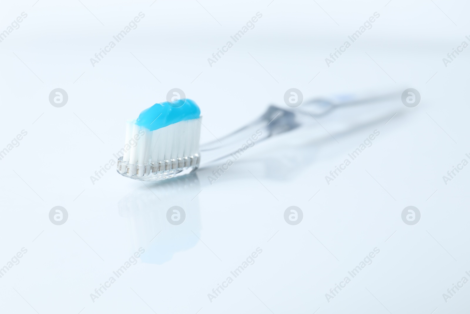 One toothbrush with toothpaste on white background Photo of One toothbrush with toothpaste on white background