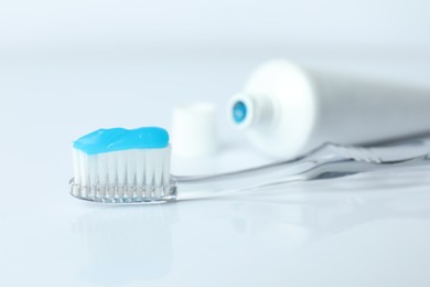 Photo of Toothbrush with toothpaste and tube on white background