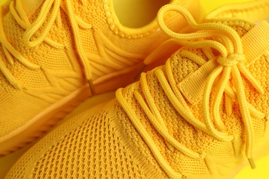 Photo of Pair of stylish sneakers as background, closeup