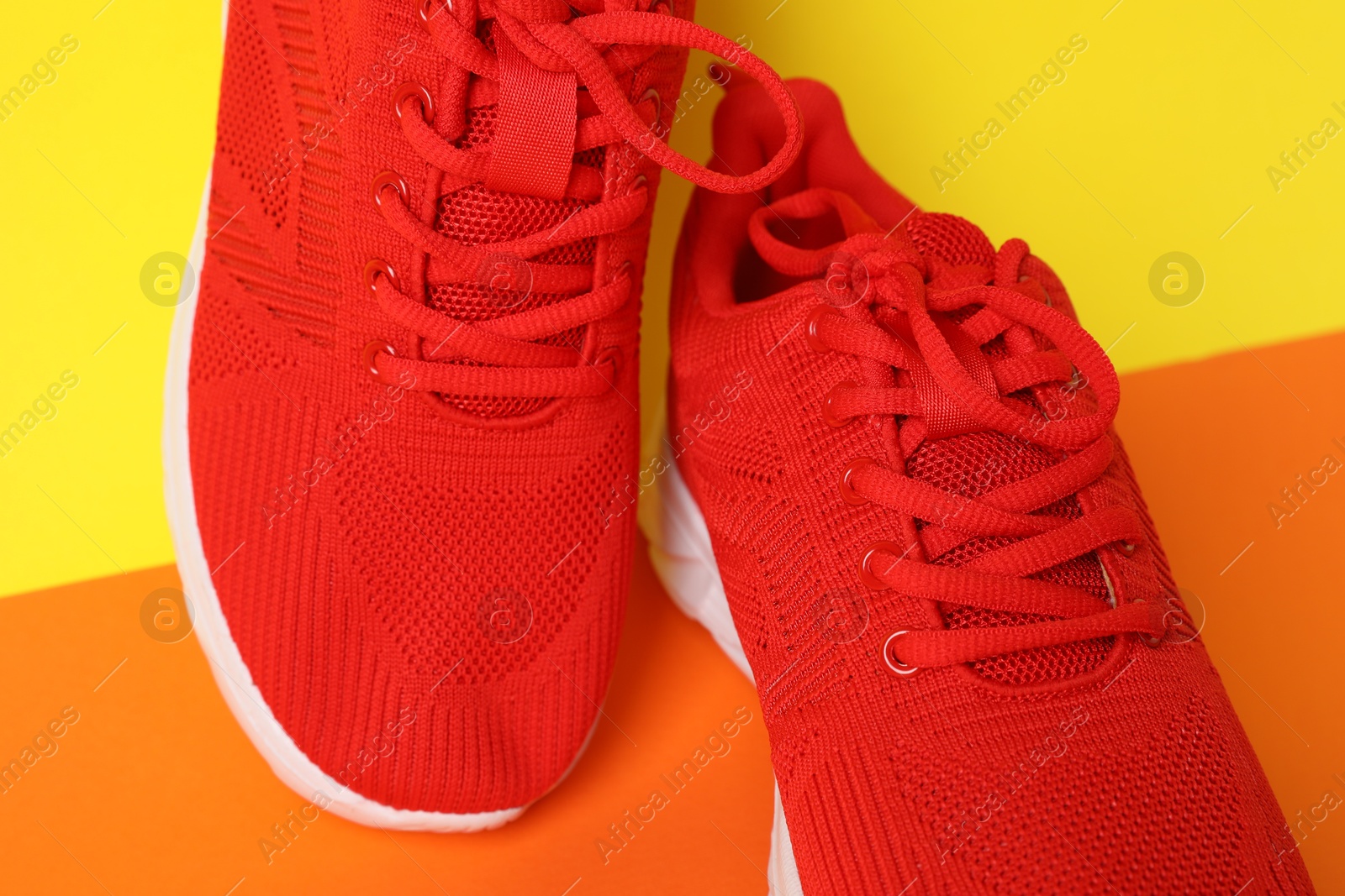 Photo of Pair of stylish sneakers on color background, closeup