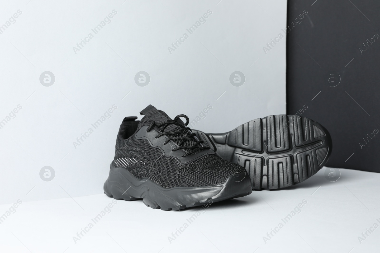 Photo of Pair of stylish sneakers on color background