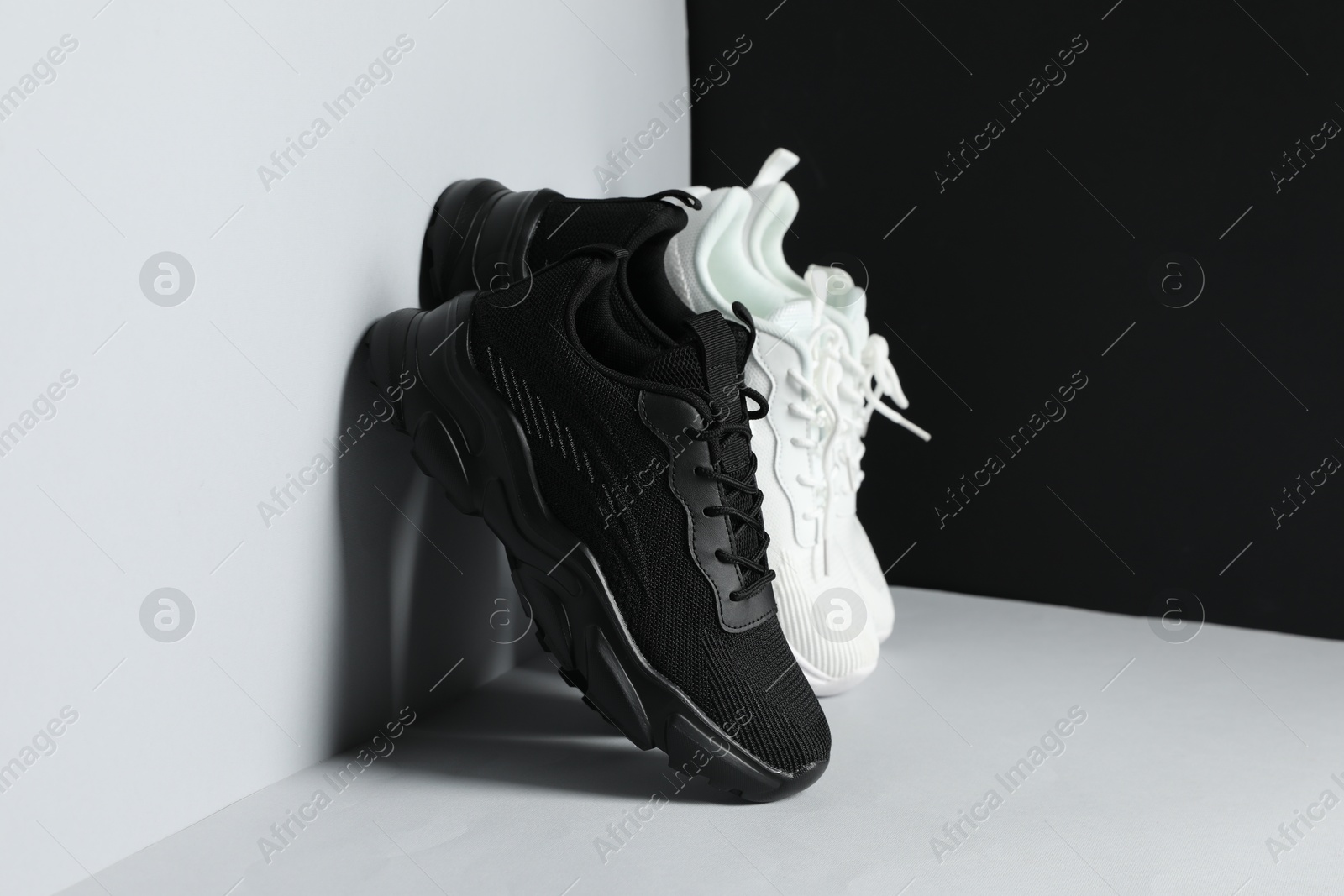 Photo of Stylish sneakers on color background. Comfortable sportswear